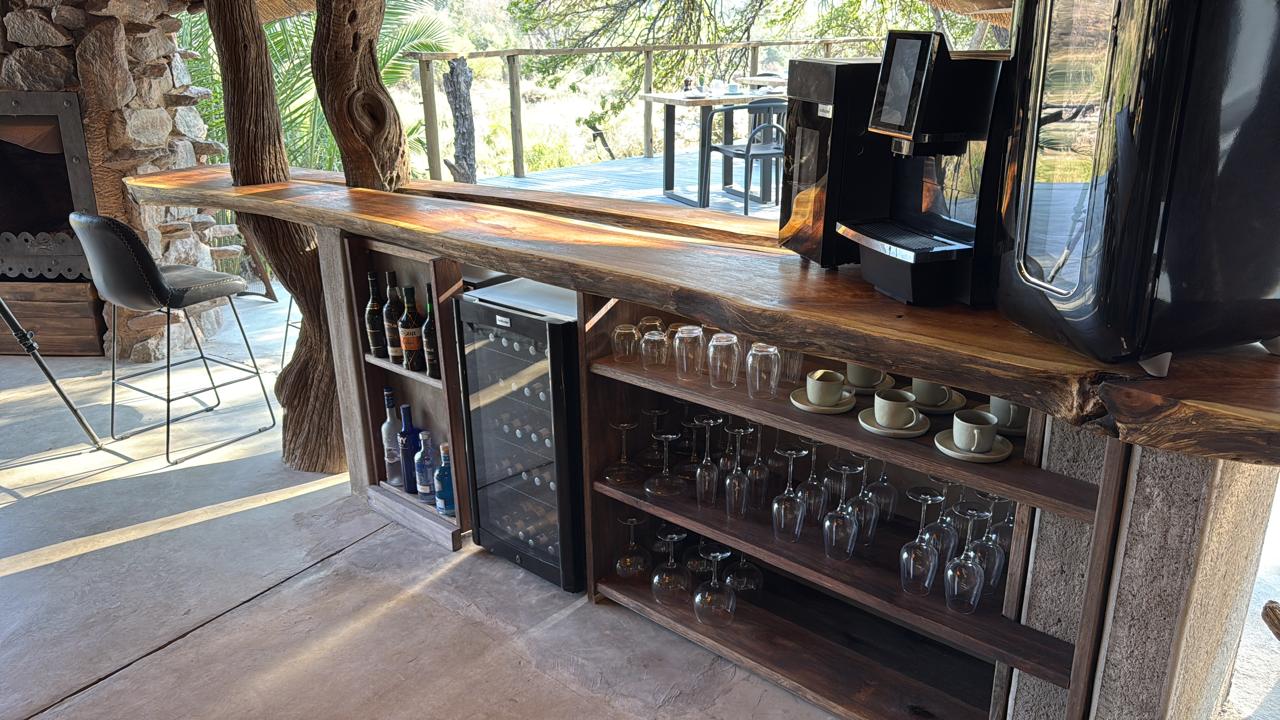 Live-edge timber bar with wine fridge and coffee station