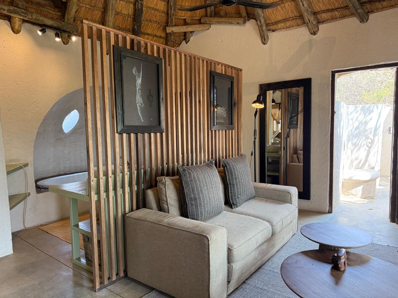 Timber slat room divider and live-edge coffee tables in a lodge suite