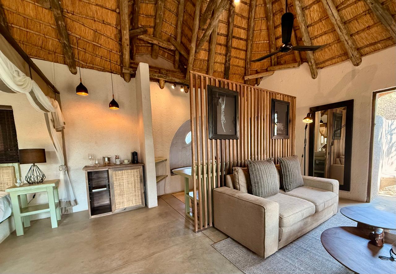 Lodge suite with timber slat divider, thatch and custom joinery