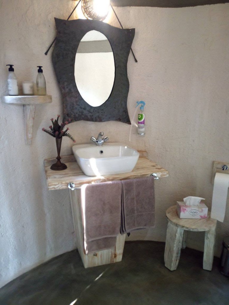 Whitewashed bathroom vanity with vessel sink and matching stool