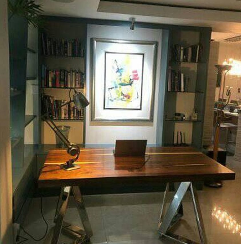 Solid timber slab desk on steel A-frame trestles in a home office