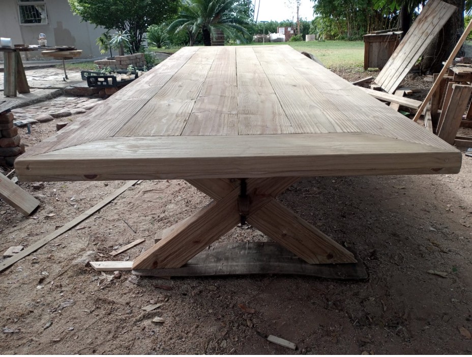 Light timber X-base trestle dining table